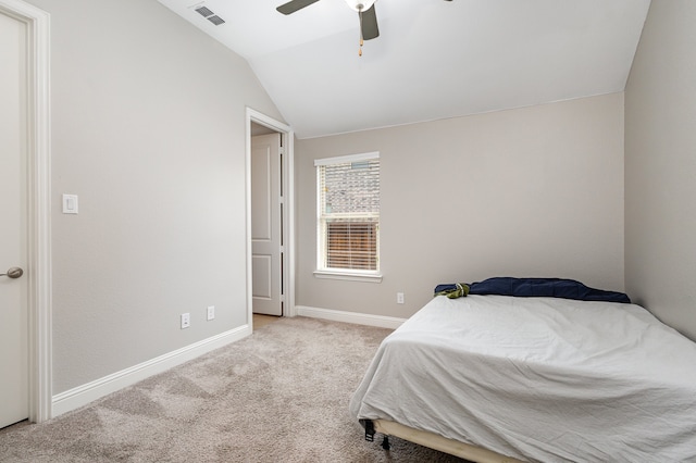 carpeted bedroom with vaulted ceiling and ceiling fan