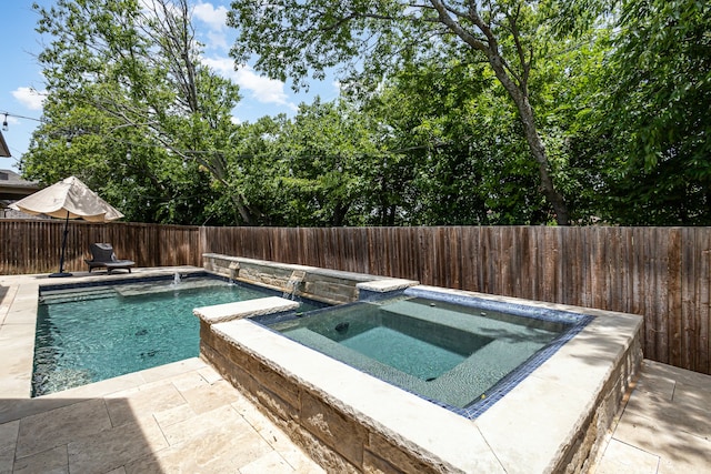 view of pool with an in ground hot tub and a patio area