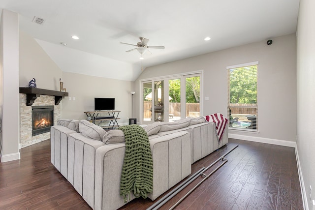 living room featuring ceiling fan, lofted ceiling, dark hardwood / wood-style floors, and a fireplace