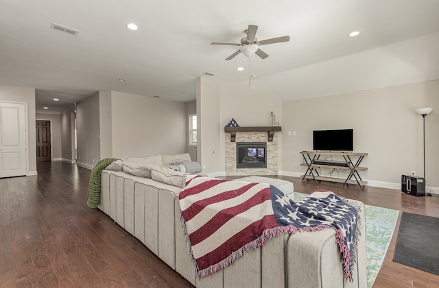 living room featuring ceiling fan, vaulted ceiling, dark hardwood / wood-style floors, and a fireplace