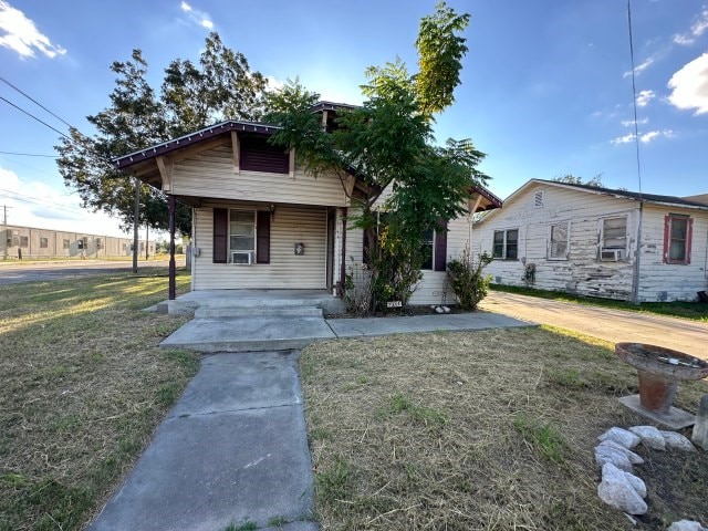 bungalow-style house with a front yard