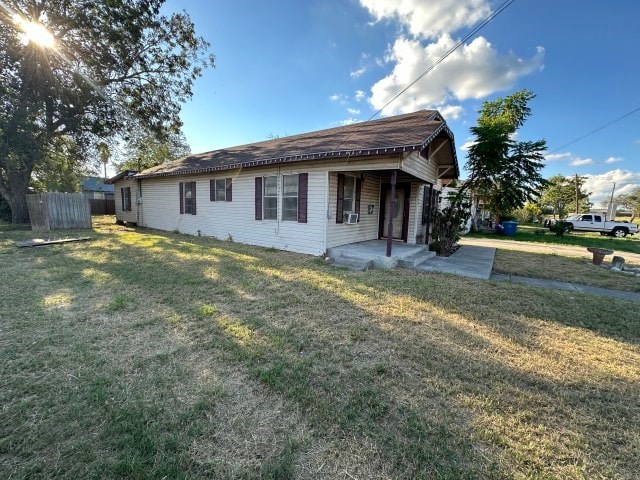 view of side of home featuring a yard and a patio area