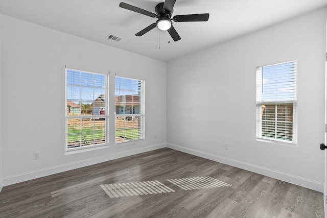 unfurnished room with dark hardwood / wood-style flooring and ceiling fan