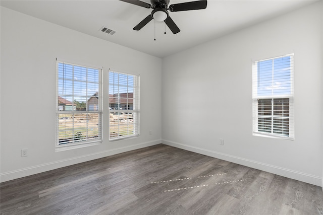 empty room with hardwood / wood-style flooring and ceiling fan