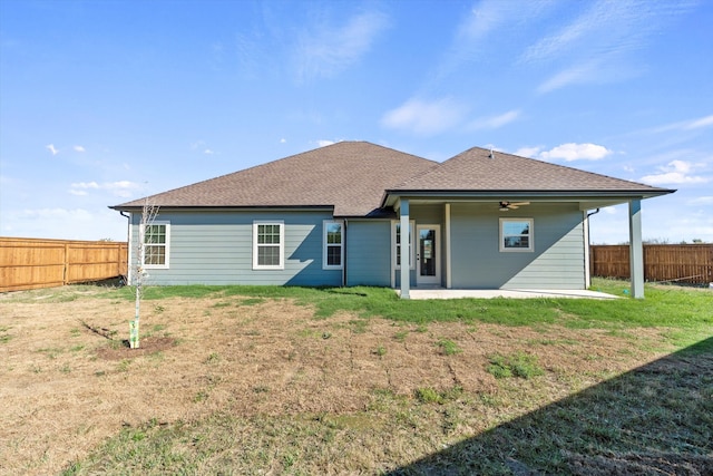 back of property with a patio area, ceiling fan, and a yard