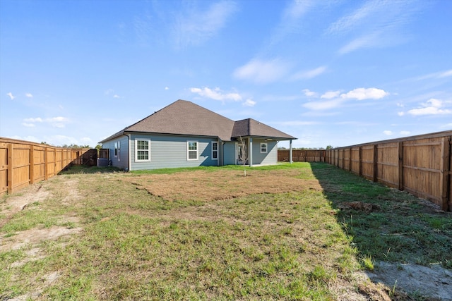 rear view of property with a yard