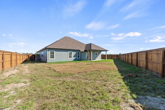 rear view of house with a lawn