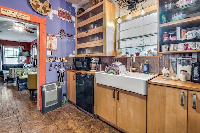 kitchen with sink, butcher block countertops, ceiling fan, heating unit, and black appliances