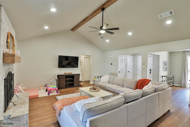 living room featuring beamed ceiling, a fireplace, wood-type flooring, high vaulted ceiling, and ceiling fan