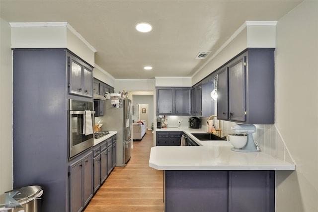 kitchen with kitchen peninsula, sink, oven, and light hardwood / wood-style floors