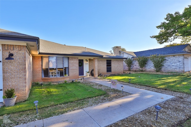 ranch-style home with a front lawn