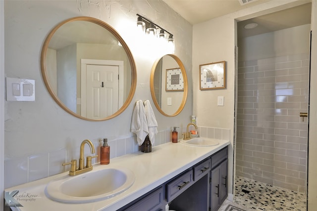 bathroom with vanity and a tile shower