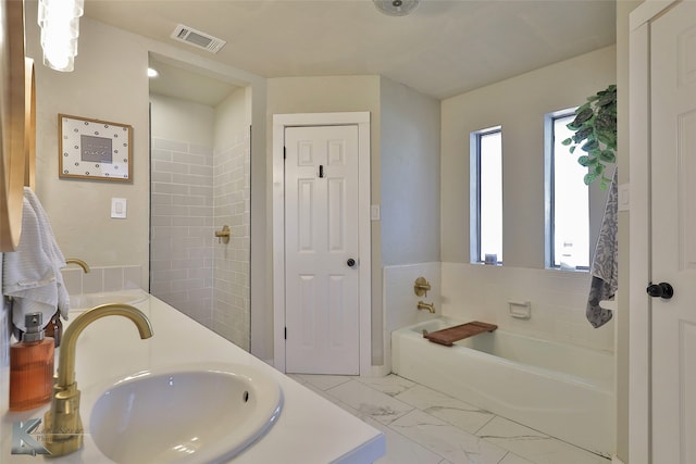 bathroom with vanity and a washtub