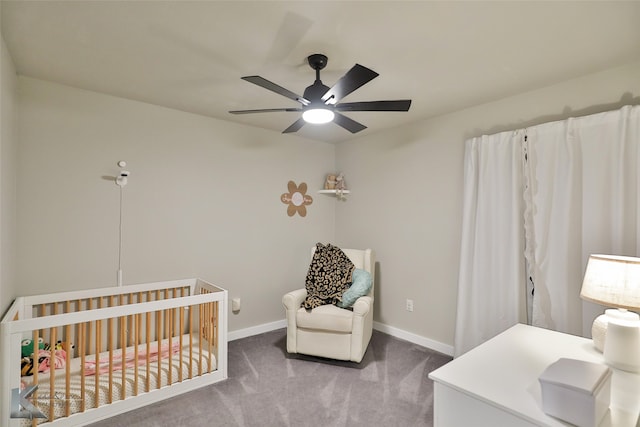 bedroom featuring a crib, ceiling fan, and carpet