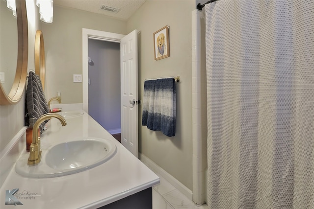 bathroom with walk in shower, a textured ceiling, and vanity