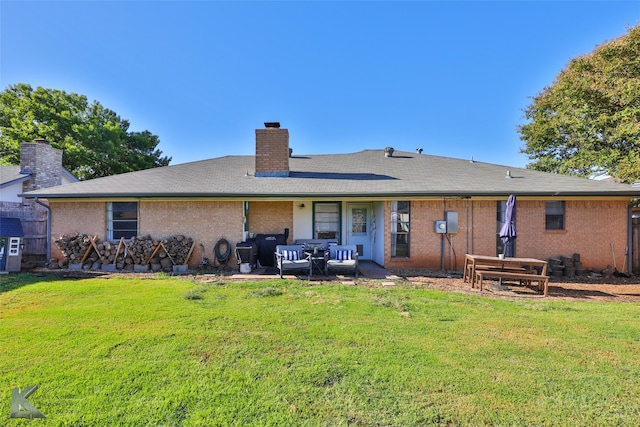 back of property with a lawn, a patio, and an outdoor hangout area