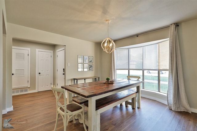 dining room with a chandelier and hardwood / wood-style flooring