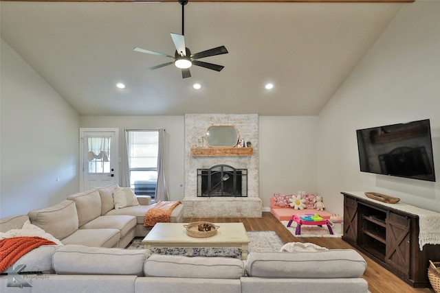 living room featuring a fireplace, high vaulted ceiling, hardwood / wood-style flooring, and ceiling fan