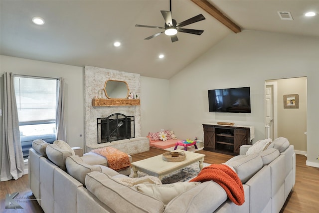 living room with beamed ceiling, a fireplace, high vaulted ceiling, hardwood / wood-style flooring, and ceiling fan