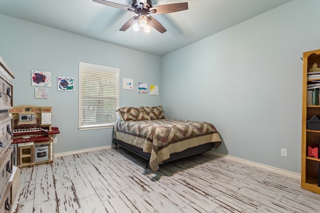 bedroom with ceiling fan and light hardwood / wood-style flooring