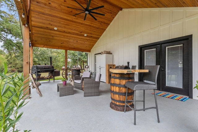 view of patio / terrace featuring an outdoor living space, a grill, ceiling fan, and an outdoor bar