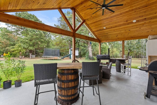 view of patio / terrace featuring a trampoline, ceiling fan, area for grilling, and a gazebo