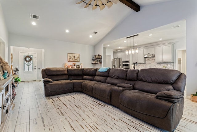 living room featuring high vaulted ceiling and beam ceiling