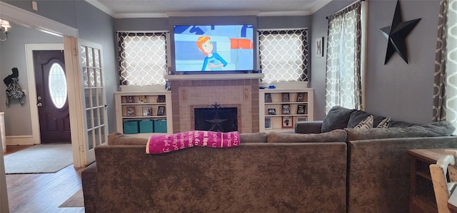 living room featuring ornamental molding, hardwood / wood-style floors, and a fireplace