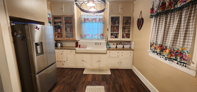 kitchen featuring dark wood-type flooring, sink, stainless steel fridge, and tasteful backsplash