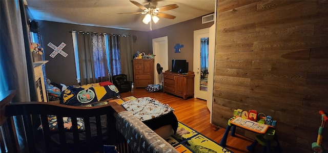 bedroom with ceiling fan and hardwood / wood-style flooring