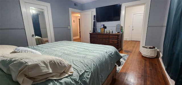 bedroom featuring a closet and dark hardwood / wood-style floors