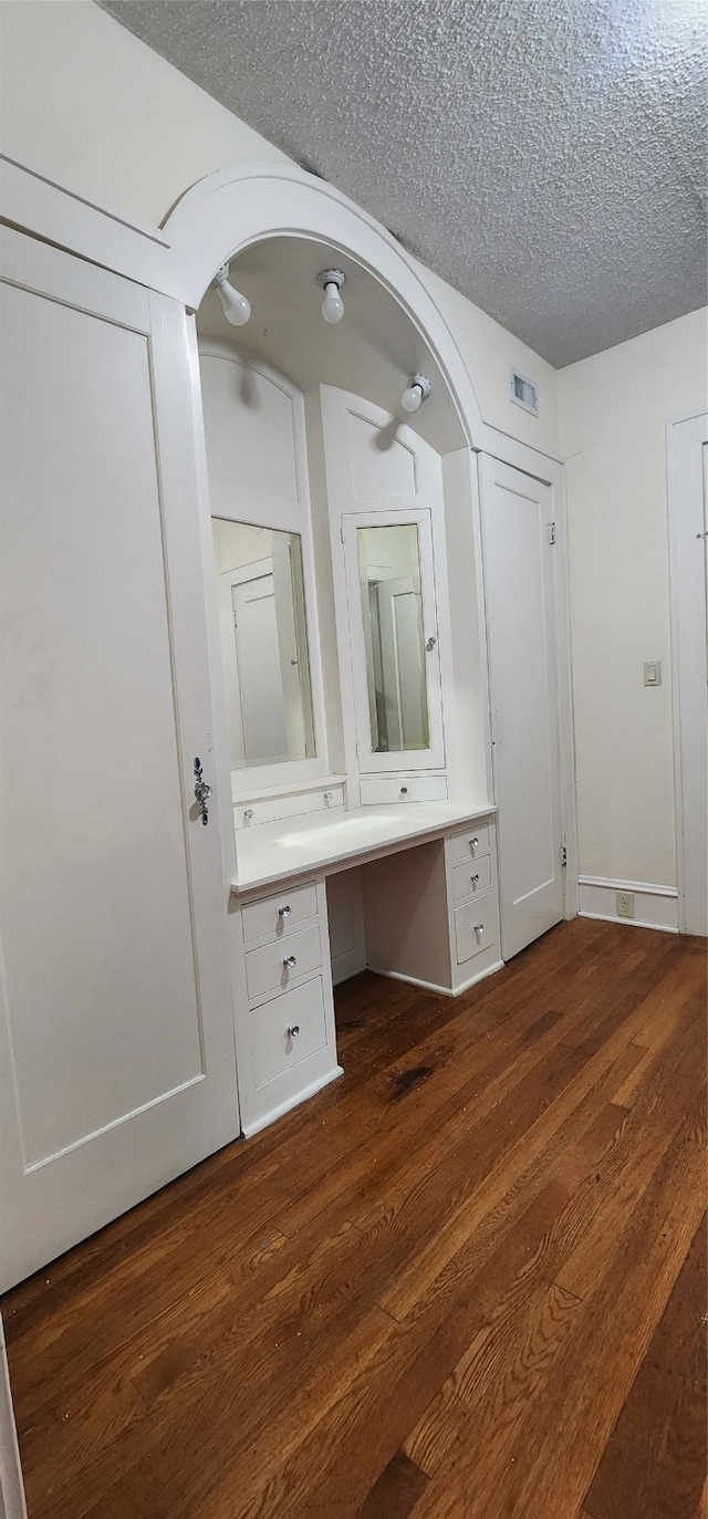 bathroom featuring a textured ceiling and wood-type flooring