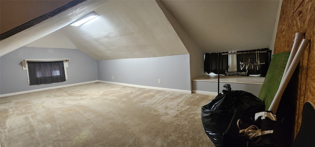 bonus room with lofted ceiling and carpet flooring