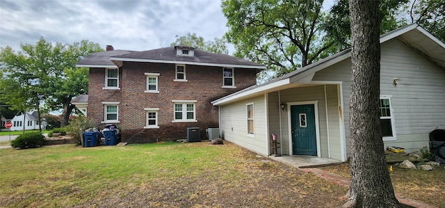 rear view of property with a yard and cooling unit