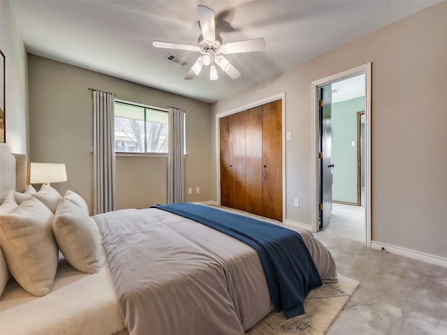 bedroom featuring a closet, ceiling fan, and light colored carpet