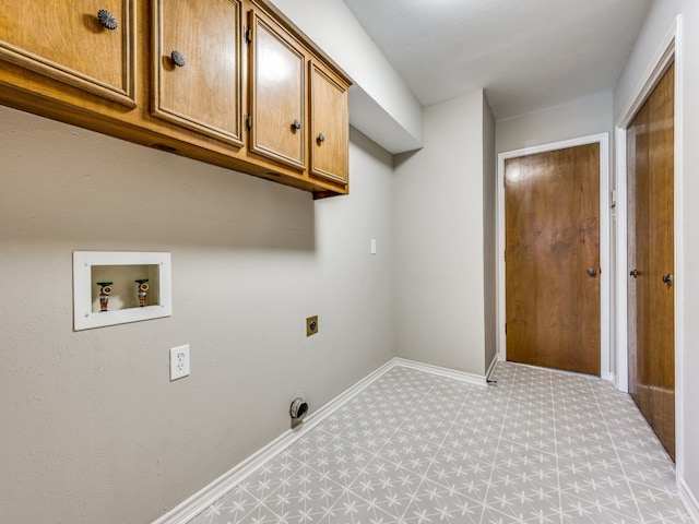 clothes washing area with cabinets, electric dryer hookup, and washer hookup