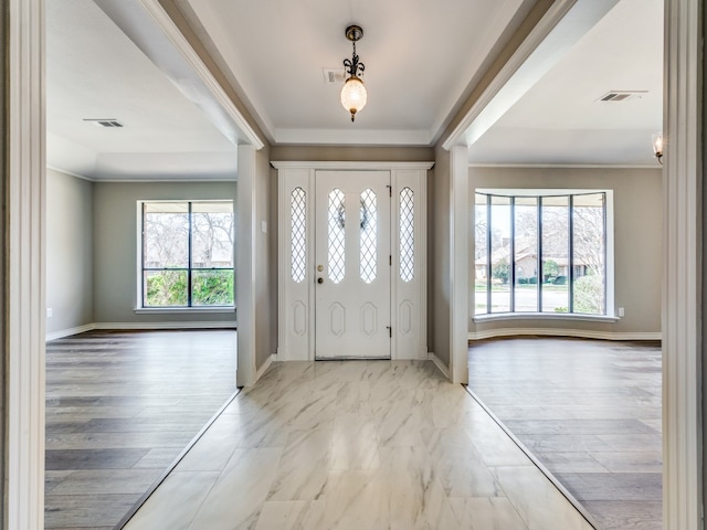 entryway with crown molding and light hardwood / wood-style flooring