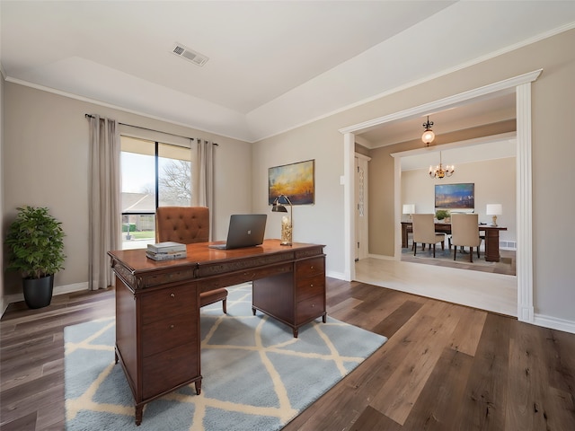 home office with hardwood / wood-style floors and a notable chandelier