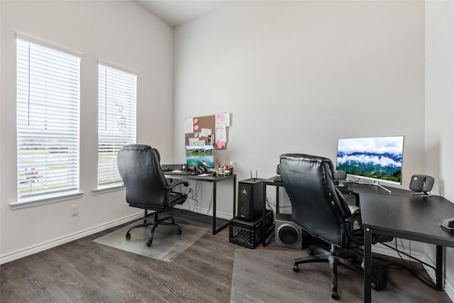 office space with plenty of natural light and hardwood / wood-style flooring