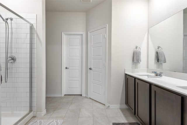 bathroom featuring vanity, walk in shower, and tile patterned flooring