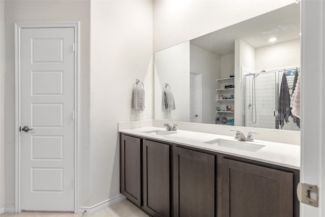 bathroom featuring tile patterned flooring, an enclosed shower, and vanity