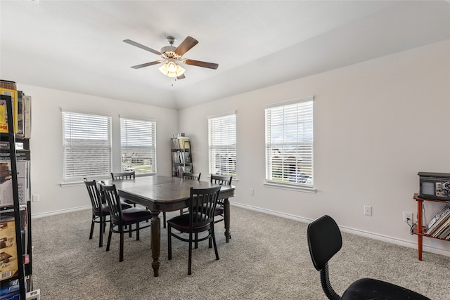 dining area featuring ceiling fan, a wealth of natural light, carpet, and vaulted ceiling