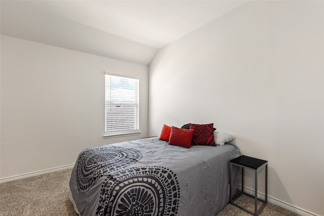 carpeted bedroom featuring lofted ceiling