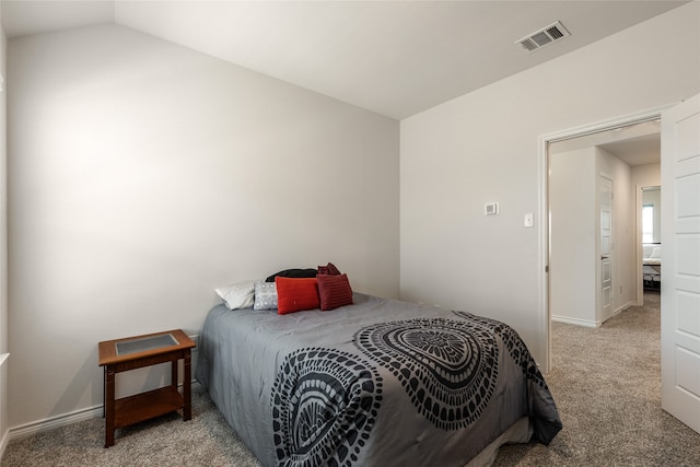 carpeted bedroom featuring vaulted ceiling