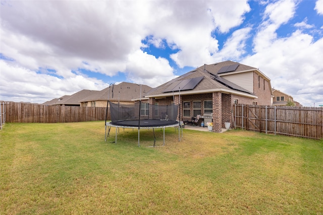 view of yard with a patio and a trampoline