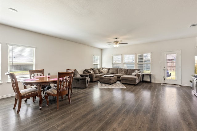 dining area with a wealth of natural light, ceiling fan, and dark hardwood / wood-style flooring