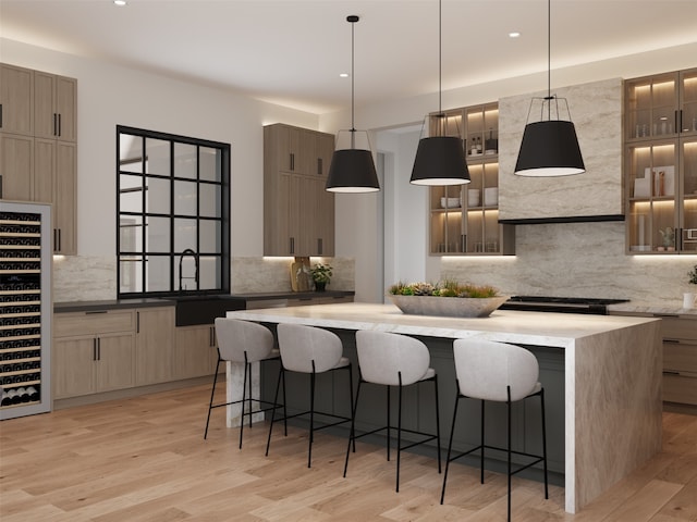 kitchen featuring a kitchen breakfast bar, a center island, light hardwood / wood-style floors, and tasteful backsplash