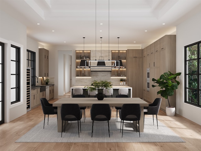 dining room featuring sink and light hardwood / wood-style floors