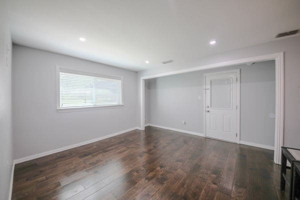 unfurnished room featuring dark wood-type flooring