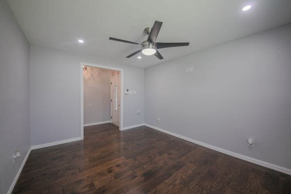 spare room featuring ceiling fan and dark hardwood / wood-style flooring